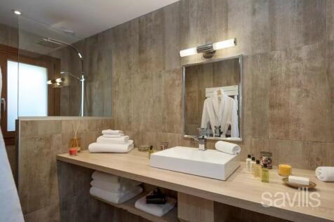 A modern bathroom with wood-textured walls feature