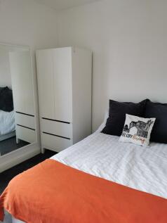 Bright, neatly presented bedroom with a comfort...