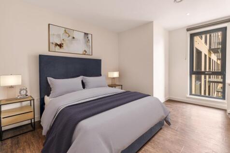 Experience serene comfort in this beautifully designed bedroom with ample natural light and sophisticated furnishings.