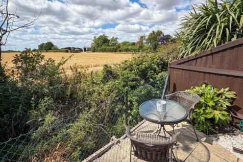 REAR PATIO AREA WITH FIELD VIEWS