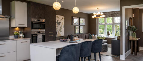 Harrogate kitchen internal with white and navy tones, plus an island with bar stools