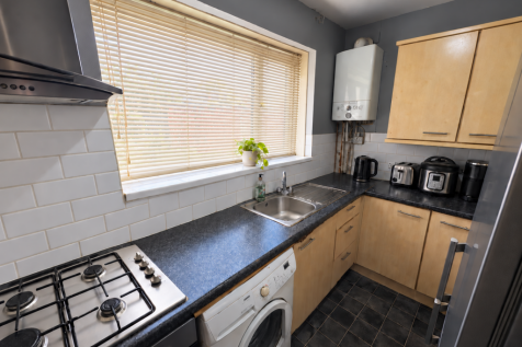 Bright kitchen with lowered Venetian blind.png