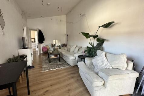 Bright lounge with comfy seating and plants...
