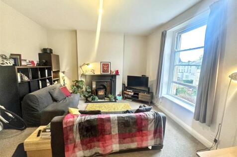 Bright living area with large windows and heart...