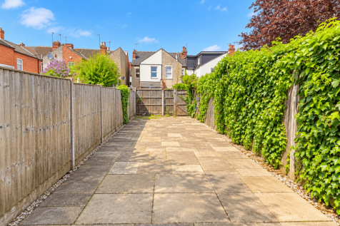 Sunny Suburban Garden Patio with Ivy Fence