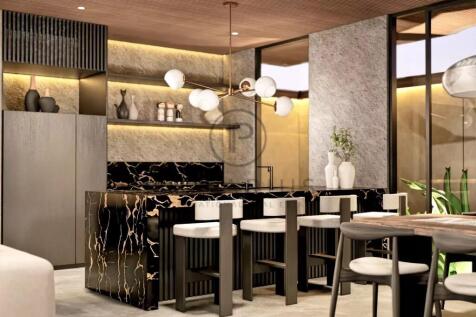 A modern kitchen features sleek, dark cabinetry, a