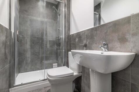 A modern, clean bathroom featuring a spacious s...