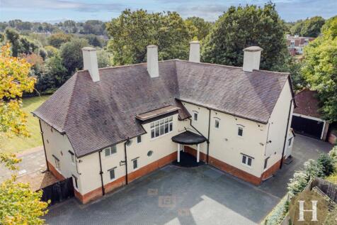 Spacious 7-bed character home on Meadow Road with 4000 sq ft, three receptions, bespoke kitchen, private garden, double garage, and gated drive. Includes en-suites, utility, and flexible living spaces
