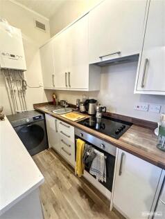 Bright modern kitchen with integrated appliance...
