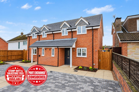 New-Build Red-Brick Home with Promotional Badges.p