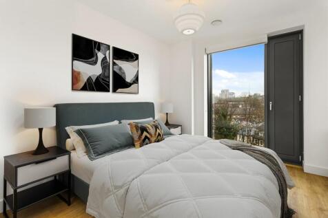 Experience tranquility in this chic bedroom filled with natural light and modern design.