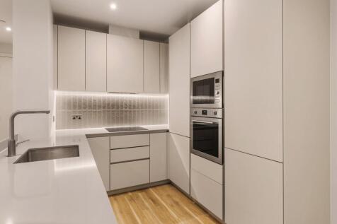 Step into this elegantly designed kitchen, where modern sophistication meets functionality.