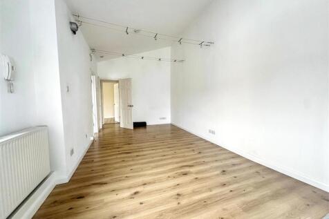 Bright living area with wood-effect flooring...