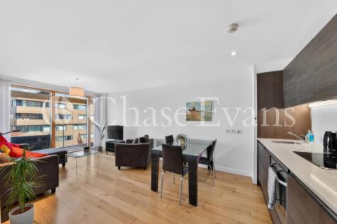 A modern, two bedroom apartment with a private balcony within O Central, Elephant & Castle SE17. There is a spacious and light open plan living area with wood flooring, high ceilings and large glass d