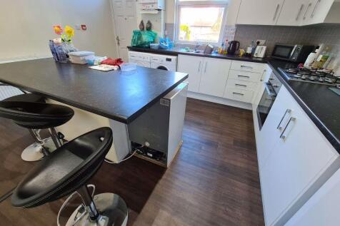 Bright and modern kitchen featuring ample count...