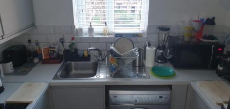 Bright, functional galley kitchen with a stainl...