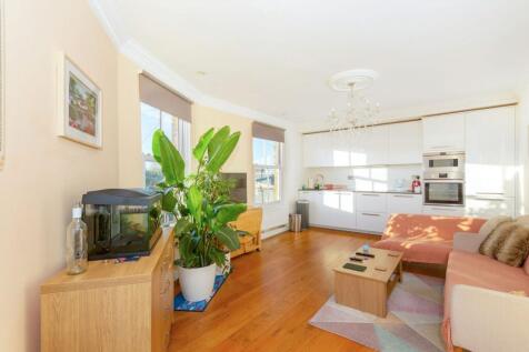 This top-floor conversion flat forms part of a characterful Victorian corner property in Brackenbury Village. Comprises an open-plan reception room with a fully fitted kitchen, two double bedrooms, an