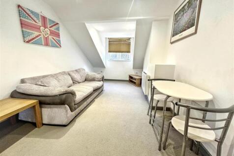 Bright lounge with plush sofa and dining area...