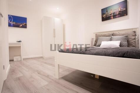A modern, well-maintained bedroom with a comfor...