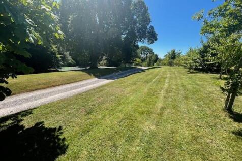 Grounds with tennis court in the distance