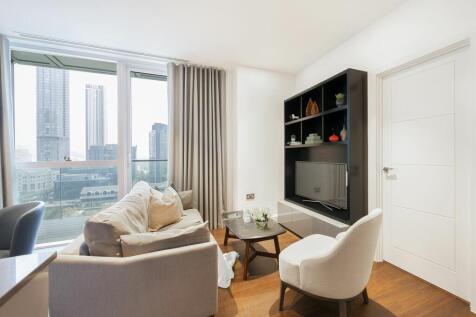 Experience urban elegance with this sunlit living room offering stunning cityscape views.