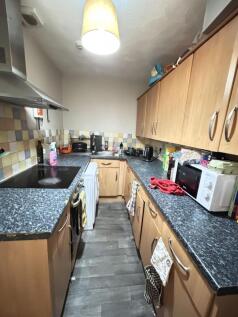 A compact and well-equipped kitchen featuring w...