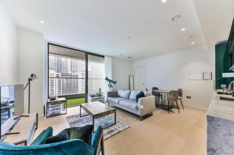 Sleek one bedroom apartment located in Wardian's Bagshaw Building, offering views of Canary Wharf and South Dock. This stylish property, c.538 sq ft, comprises an open plan kitchen living area, double