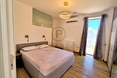 A bright and modern bedroom with a double bed, woo