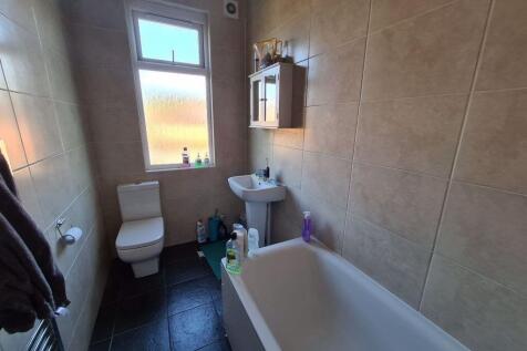 A clean and modern bathroom featuring a white b...