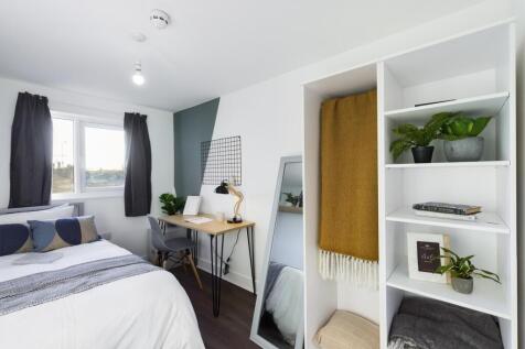 A bright and spacious double bedroom featuring ...