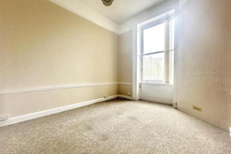 Bright bedroom with large sash window...