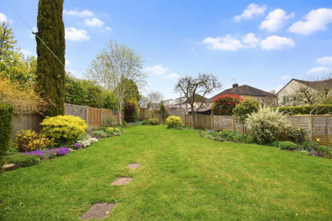 Spring garden with vibrant flowers and lawn.png