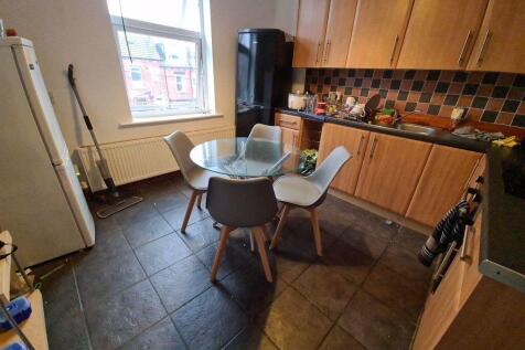 Bright kitchen featuring a modern tiled floor, ...
