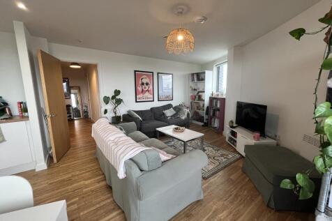 Luxury waterside living at X1 Manchester Waters, featuring a two-bedroom, two-bathroom apartment with a private balcony, allocated parking and refined modern interiors.