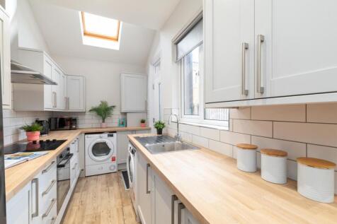 Bright, modern galley kitchen with wood-effect ...