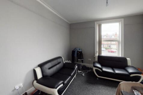 A modern, well-lit living room featuring contem...