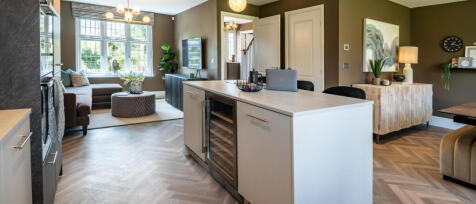 Redrow internal image of an open plan kitchen / dining / family area complete with large island cont