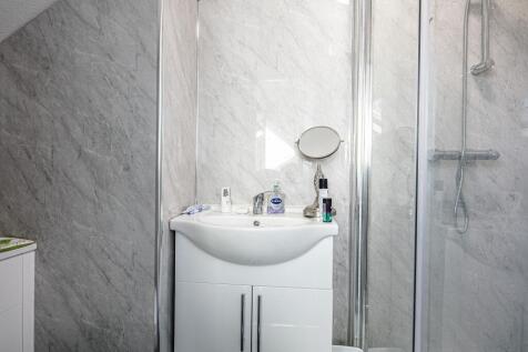 Bright modern bathroom with a white vanity sink...