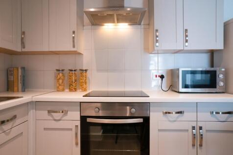 A modern and tidy kitchenette with stylish appl...
