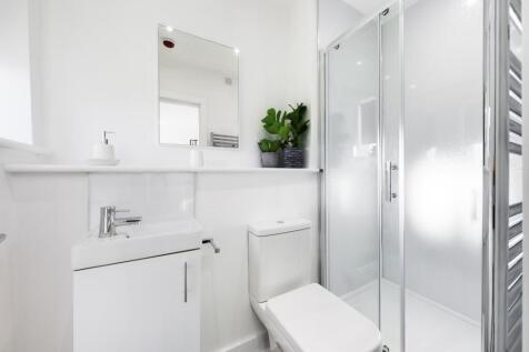 A bright and modern bathroom featuring a sleek ...