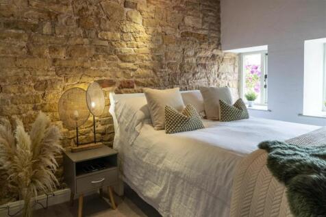 Original stone feature walls in the bedrooms