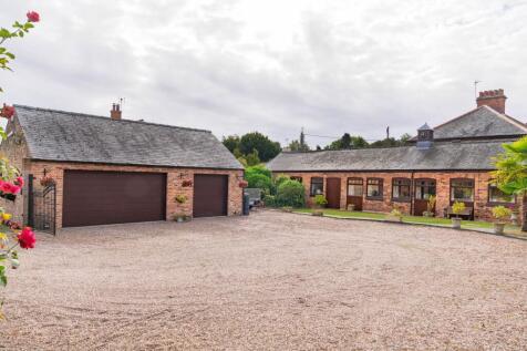 Triple garage and ample parking at front