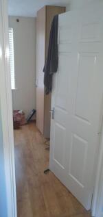 Bright, simple hallway with wood-effect floorin...