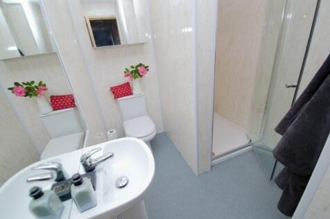Bright, modern bathroom with a walk-in shower, ...