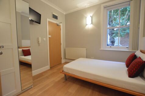 Open-plan studio on West End Lane in a period conversion. Features kitchenette, en-suite, wood floors, double bed, TV, and more. Rent includes gas central heating and water. Close to West Hampstead tr