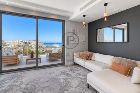 Bright living room with large glass doors leading