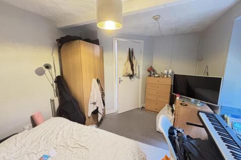 A cozy bedroom featuring a double bed, a wardro...