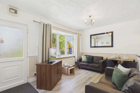 Bright Open Plan Lounge With Sofas, Dining Area An