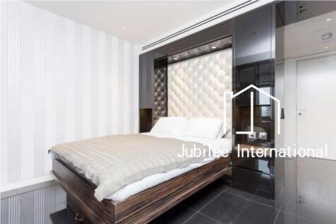 This luxury apartment offers a well sized reception area with west facing balcony, partitioned sleeping area with a desk / working space, open plan kitchen with Miele appliances, dark Porcelain floori