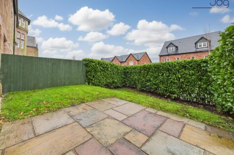 Spacious garden with a mixture of lawn and flagstone